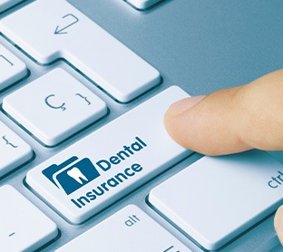 Keyboard with finger pushing button that reads Dental Insurance