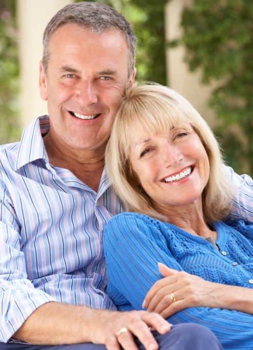 Older couple smiling after visiting their Raleigh North Carolina dentist