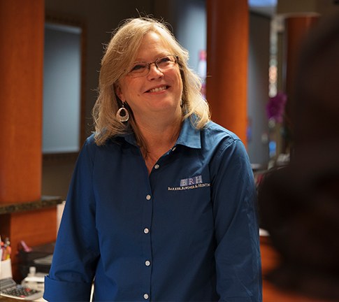 Smiling dental team member greeting dentistry patient