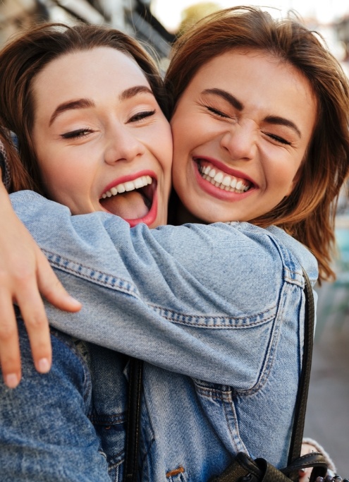 Two women with flawless smiles after cosmetic dentistry