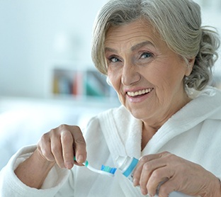 Dentures patient in Raleigh doing oral hygiene