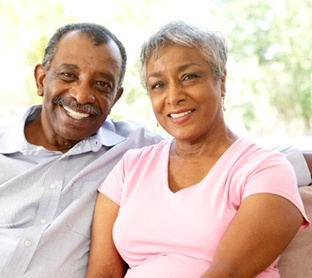 Couple with dental implants in Raleigh