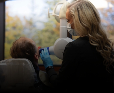Raleigh dental team member capturing digital x rays of a patient
