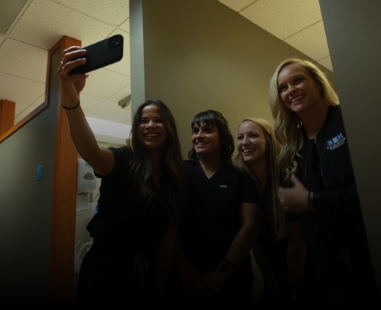 Dental team members in Raleigh taking a selfie together