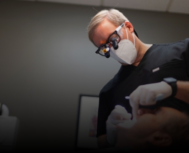 Dentist looking closely at a patient's mouth