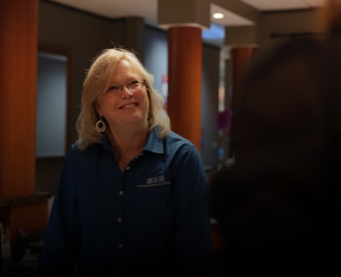 Dental team member greeting a patient in Raleigh