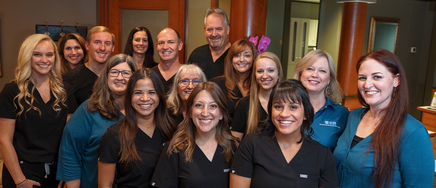 Raleigh dentists and team members smiling in dental office