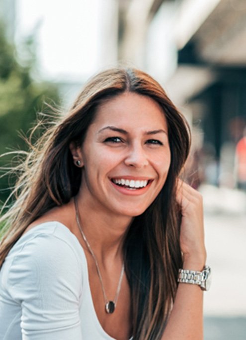 smiling woman with Invisalign in Raleigh