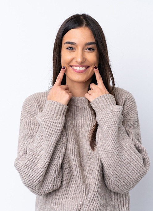 Young woman showing off her smile makeover in Raleigh