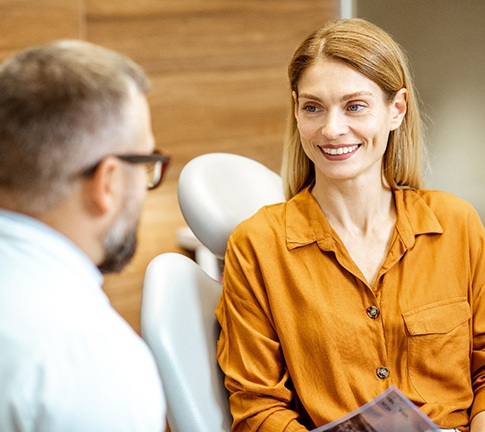 Dentist discussing how a smile makeover works with patient