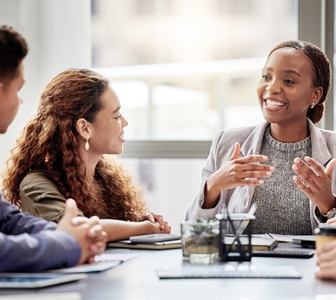 Female smiling at work among her colleagues
