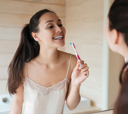 Woman holding toothbrush