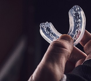 Person holding mouthguard
