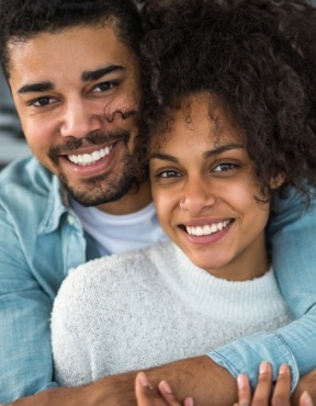 Man and woman with healthy smiles thanks to preventive dentistry