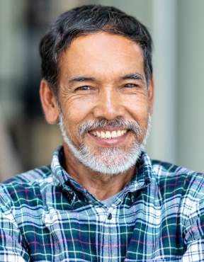 Man with perfectly aligned smile after orthodontic treatment