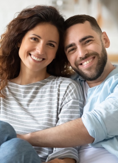 Man and woman smiling after visiting dentist for advanced dental services and technology in Raleigh