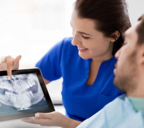 Dental team member and patient reviewing all digital x-rays