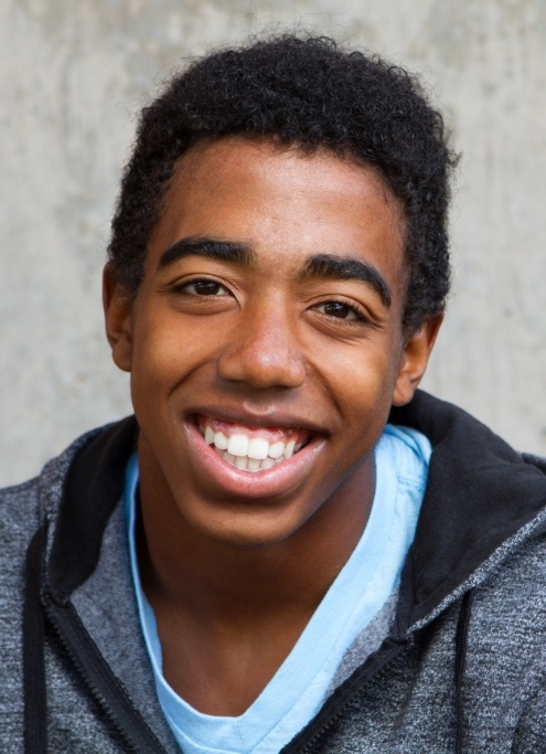 Young man smiling after wisdom tooth extractions