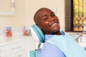 patient smiling after meeting dentists