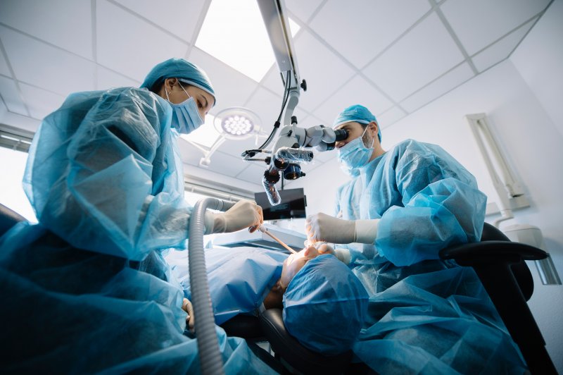 Dentists performing dental implant surgery