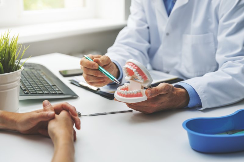 A dentist discussing dental implant success with a patient