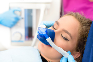 Female patient having mask placed for dental sedation