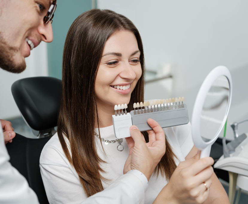 Dentist showing patient veneers