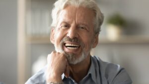 Man smiling with white dentures