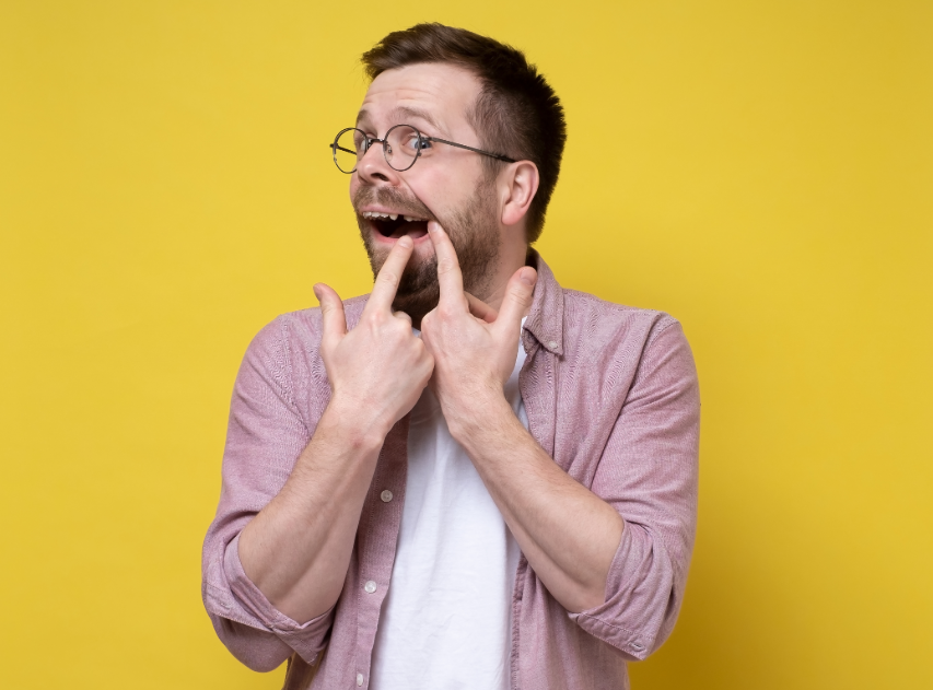 Man pointing at missing tooth